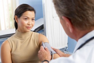 getty_rf_photo_of_woman_getting_blood_pressure_checked